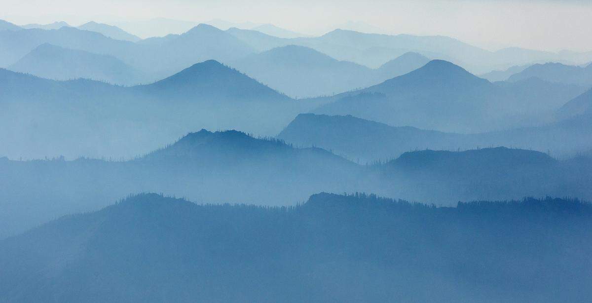 The mountains east of McCall, as seen in August cloaked in smoke aboard an EcoFlight, are the historic lands of the Nez Perce Tribe, and where they still maintain access rights through U.S. treaty. Some of the hillsides are also lined with gold, and sought-after critical minerals such as antimony.