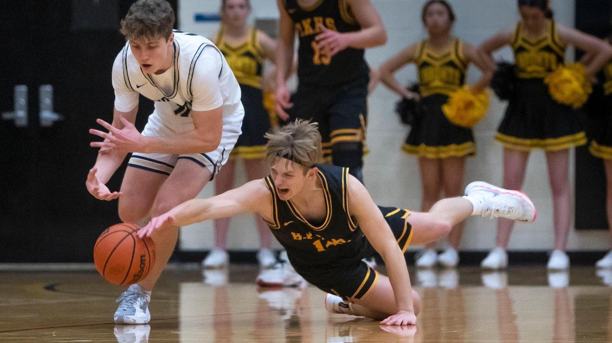 Bishop Kelly guard Gage Alves dives for a loose ball defending Middleton’s Talmage Stucki on Friday at Bishop Kelly High.