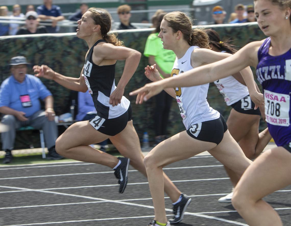 Mountain View’s Jasmine Devers, left, crosses the finish line first in the 5A girls 100-meter dash at the state track and field championships at Eagle High on Saturday, May 18, 2019.