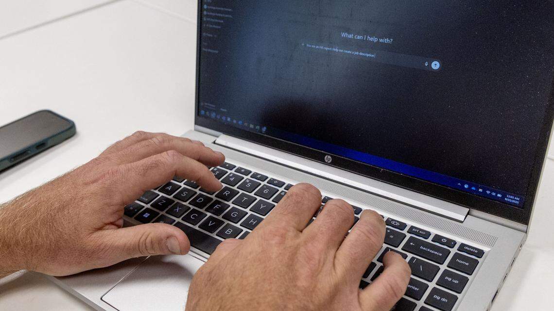 Kyle Patterson, director of organizational effectiveness for the City of Boise, types in a ChatGPT prompt to create a job description while demonstrating the AI technology.