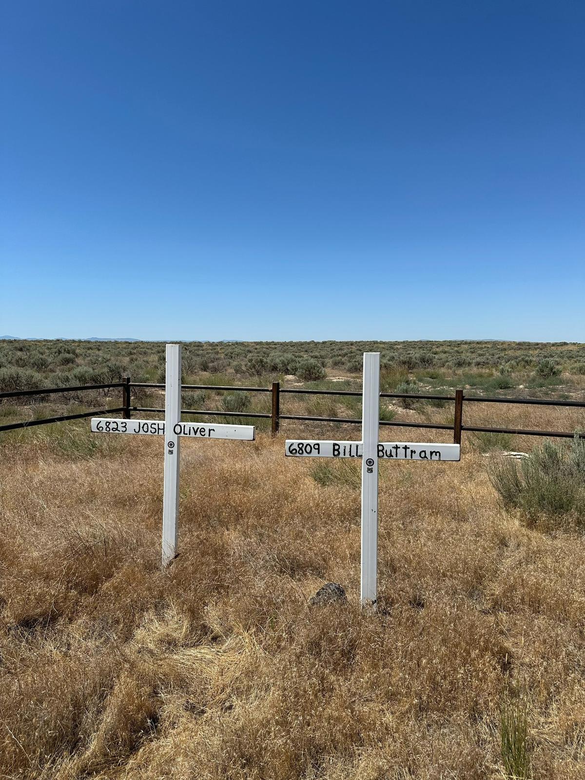 Two white crosses that are part of the Point Fire Memorial on Swan Falls Road seven miles south of Kuna stand in stark contrast to the brown desert landscape, marking the spot where Kuna firefighters Bill Buttram and Josh Oliver were killed on July 28, 1995, in the Point Fire.