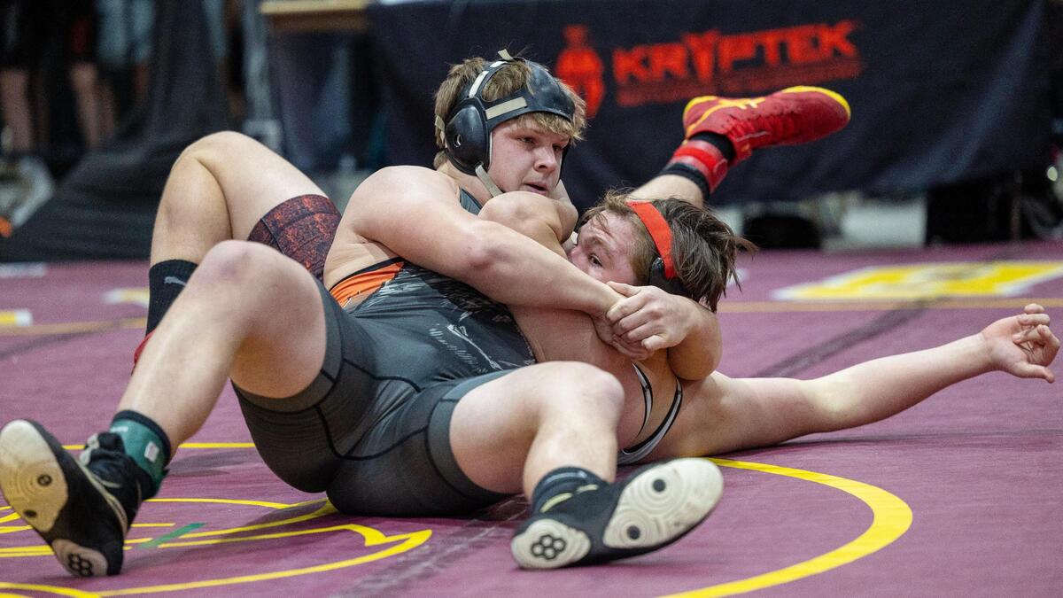 Fruitland’s Quinn Hood pins Owyhee’s Maxim Osmond in the 195-pound championship at the Rollie Lane Invitational last season.