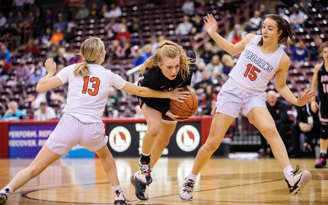 Boise’s Avery Howell splits Post Falls’ Brooklynn Brennan and Capri Sims during the first round of the 5A girls basketball state tournament Thursday at the Ford Idaho Center.
