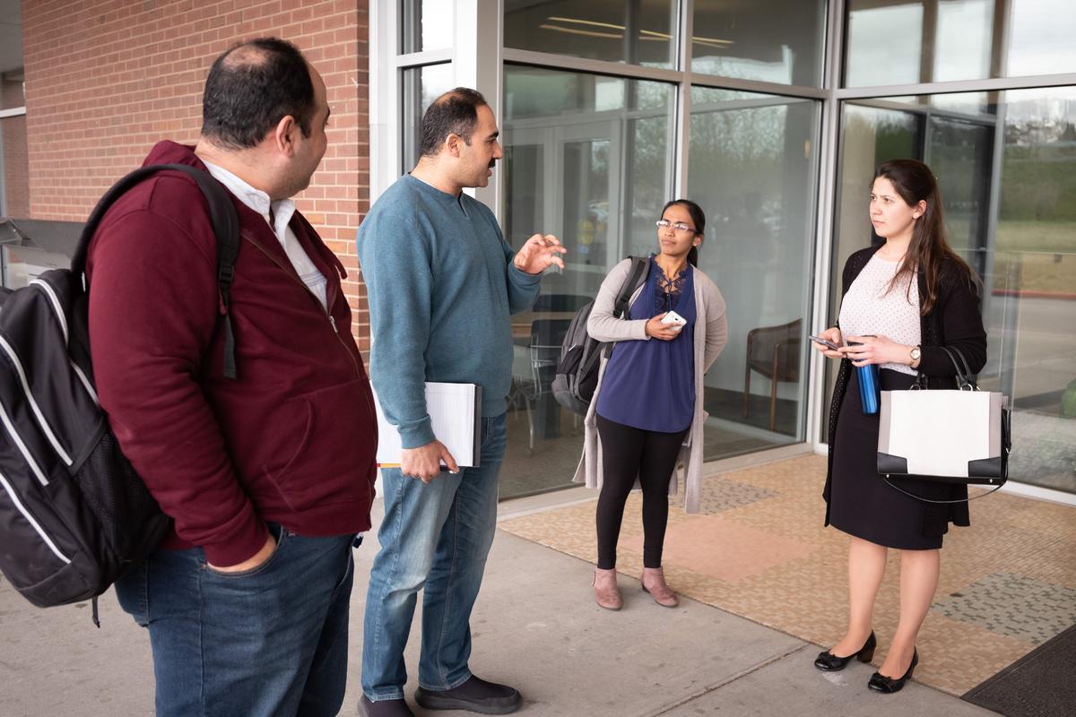 Brothers Salwan Swidan and Marwan Sweedan speak with Drs. Sanda Karunathilake and Elvira Kravchenko outside the library where they meet every week for a 3 hour study session.