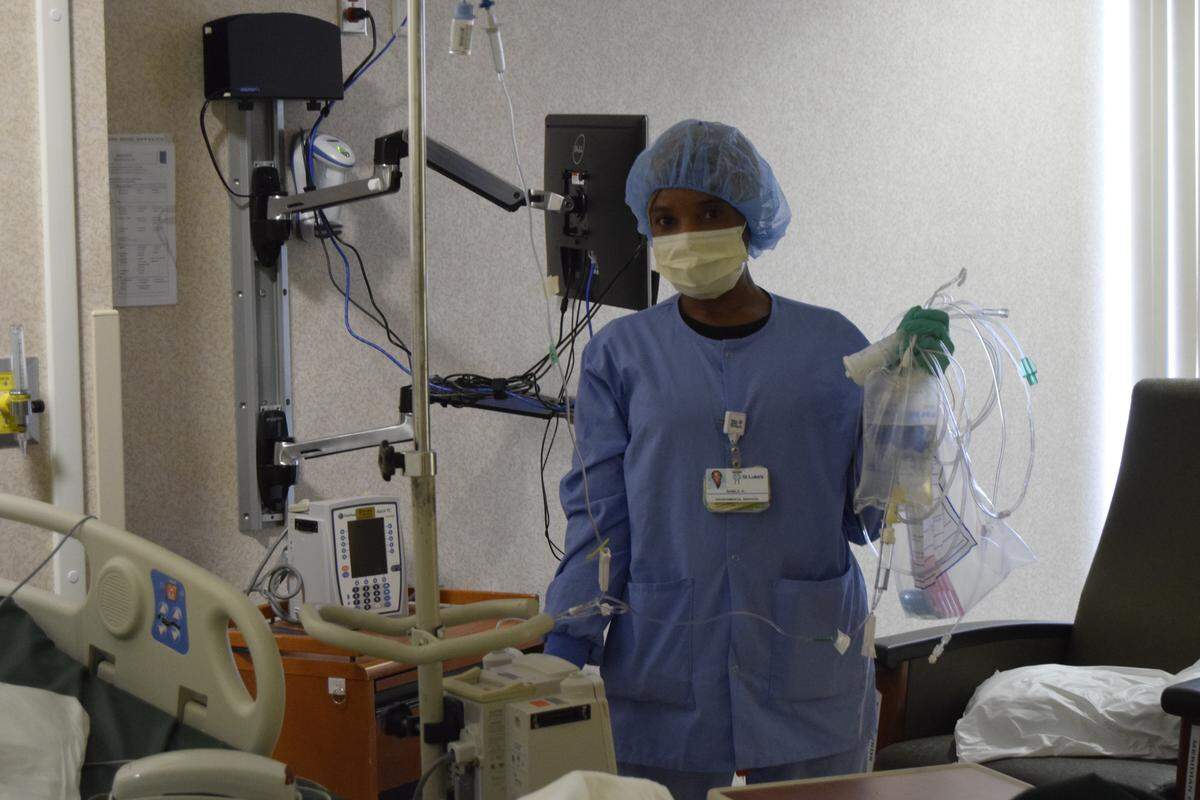Nabila Hamid, an Environmental Services Technician and recent refugee from the Sudan, is responsible for cleaning the rooms of COVID-19 patients at St. Luke’s Meridian Medical Center.