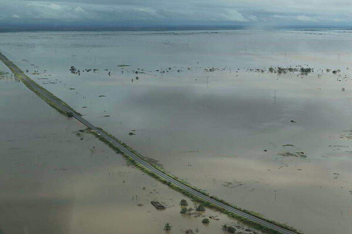 A road in Mozambique is completely surrounded by floodwater.