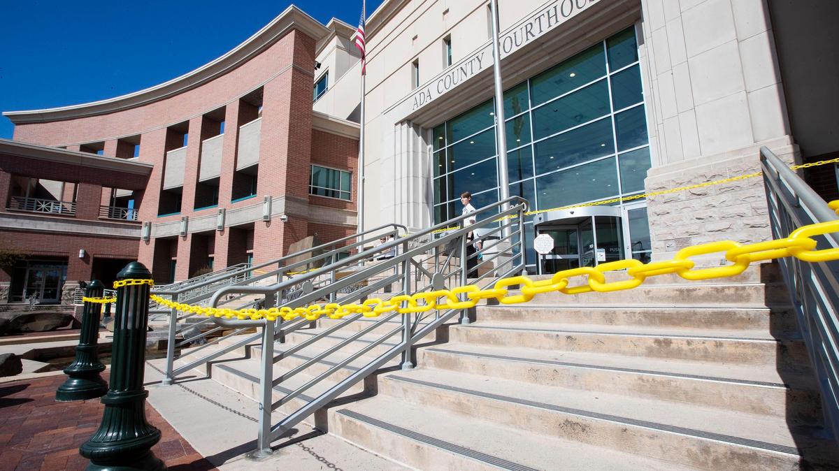 Security stands watch outside of the Ada County Courthouse after the building was closed in March. Those visiting the courthouse now must wear masks on certain floors, because of a spike in COVID-19 cases.