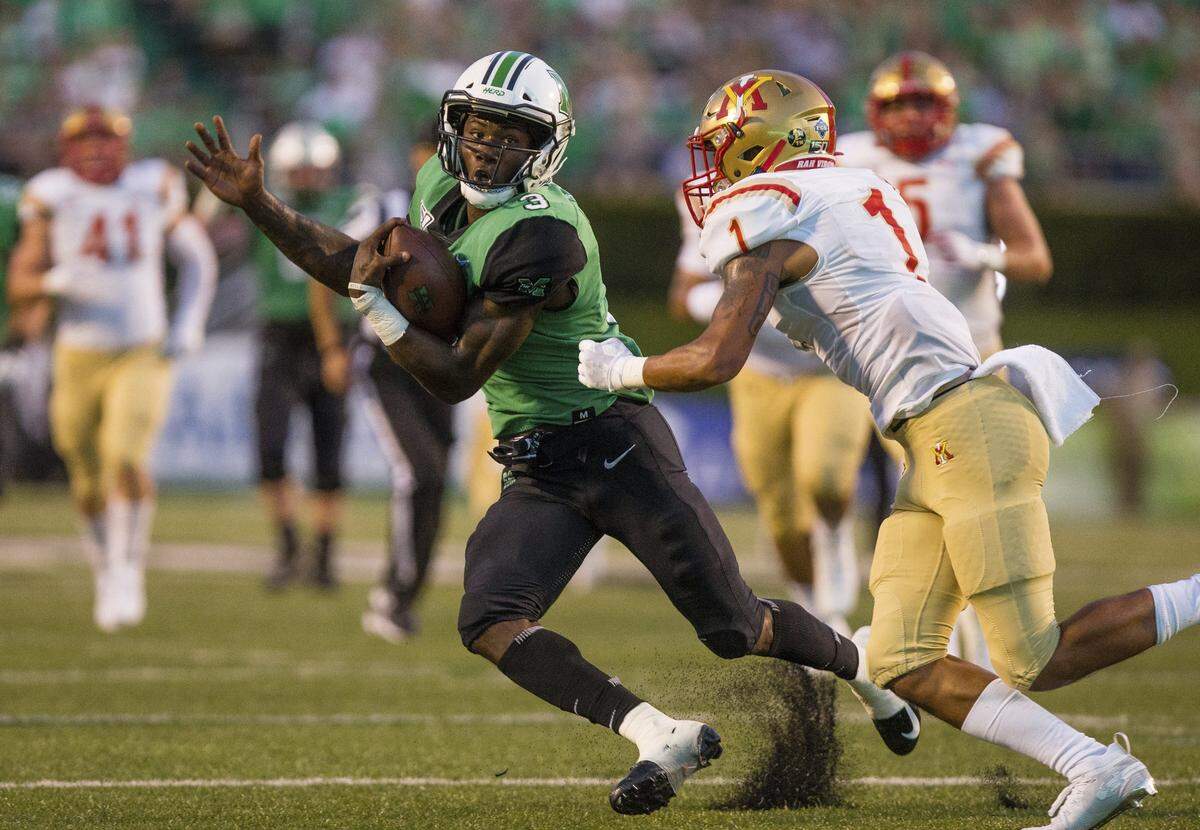 Marshall running back Tyler King breaks upfield on a carry against VMI’s Kaleb Tucker.