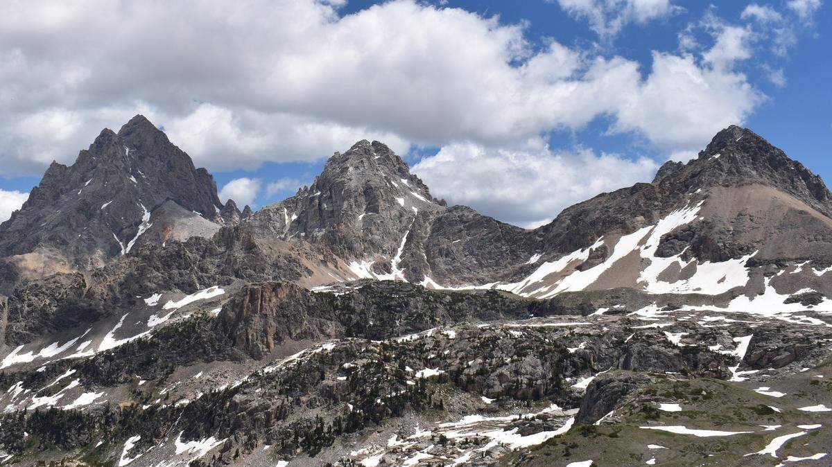 This photo shows three peaks that are part of the Grand Teton mountain range: (from left to right) Grand Teton, Middle Teton and South Teton. On July 20, a climber died in a 40-foot fall on a route of the Grand Teton peak, rangers said.
