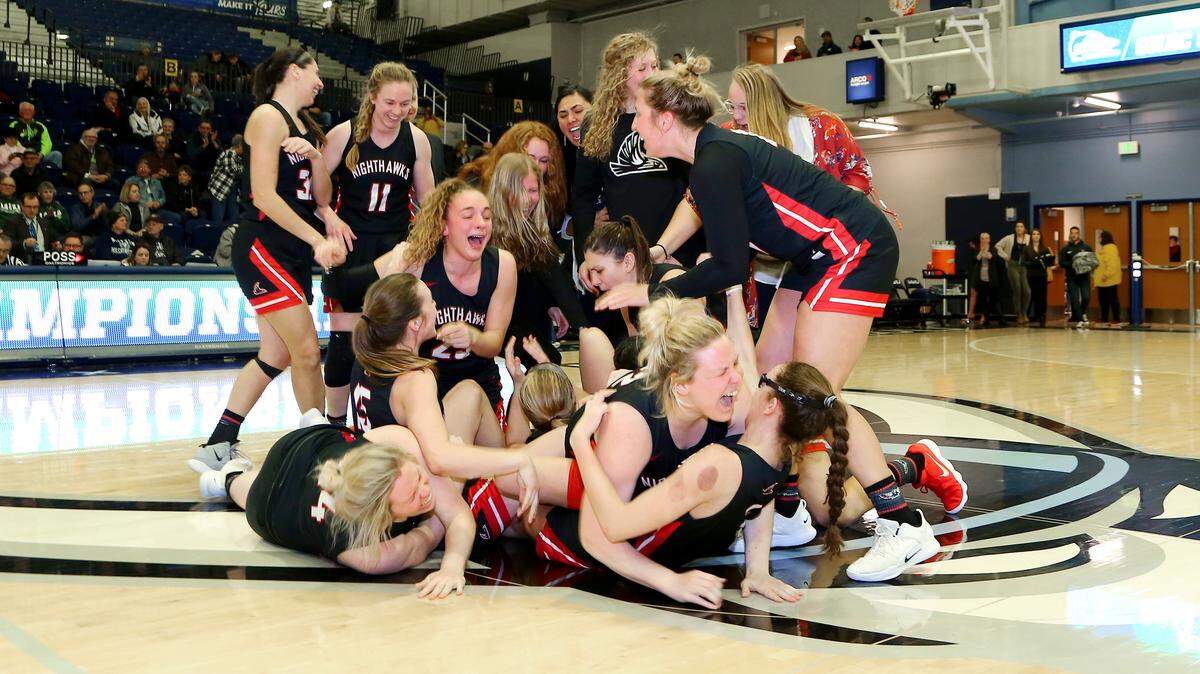 The Northwest Nazarene women’s basketball team celebrates the program’s first GNAC Tournament championship on Saturday in Bellingham, Washington.