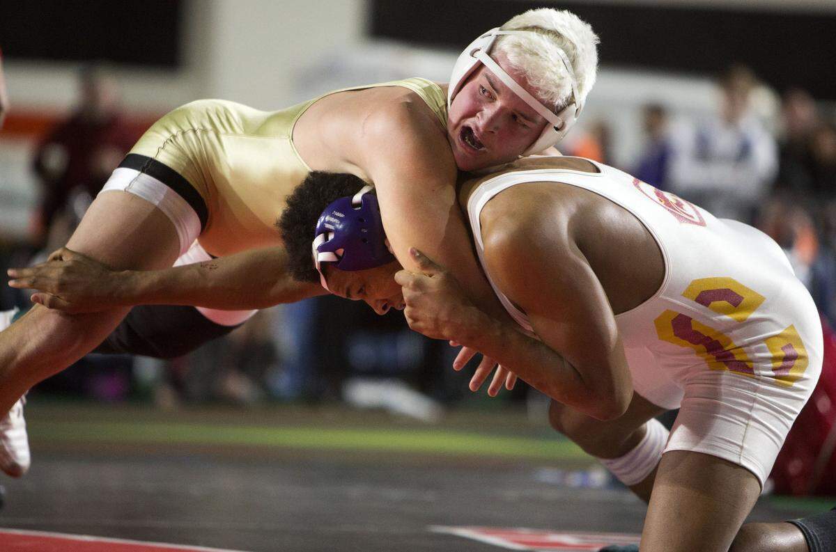 Capital’s Abe Turpen grapples with Columbia’s Michael Cox in the 5A state championship match last year. Both are returning this season.