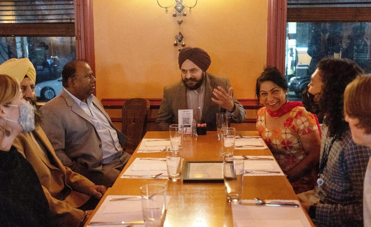 Boise resident Gurtej Sandhu, center, leads a conversation before dinner at the Sikh Awareness and Appreciation Month event at Bombay Grill.