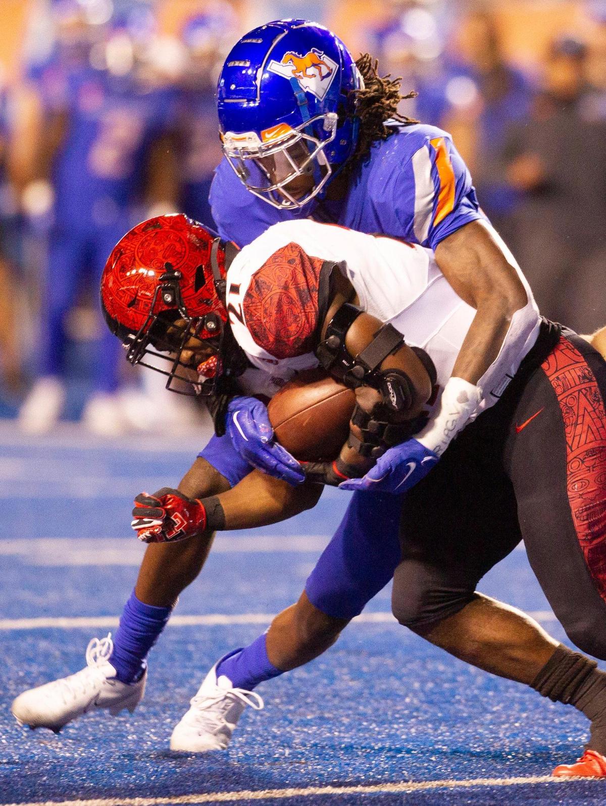 Boise State nickel Tyreque Jones takes down San Diego State running back Chance Bell on Friday night.