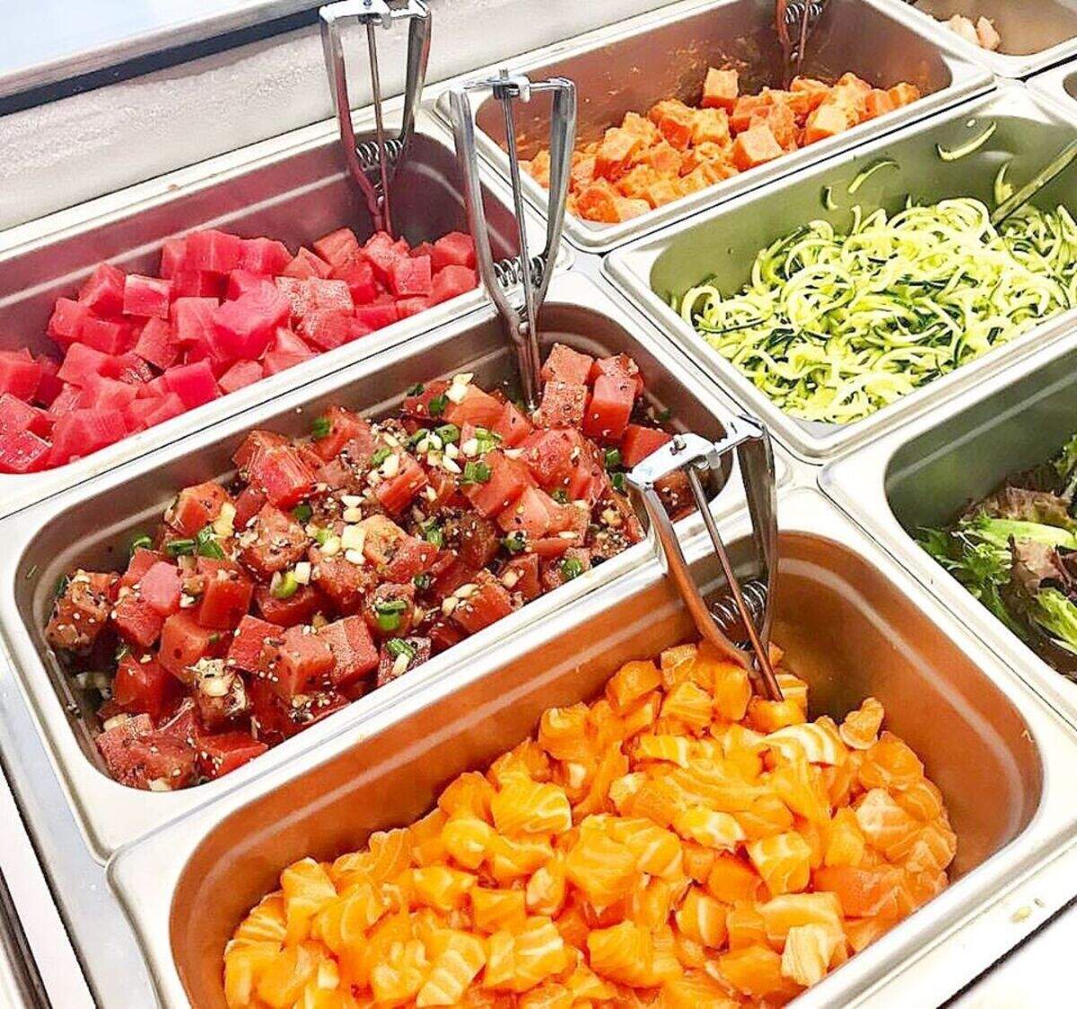 Proteins and vegetables at Paddles Up Poke are set up for customizable bowls and burritos.