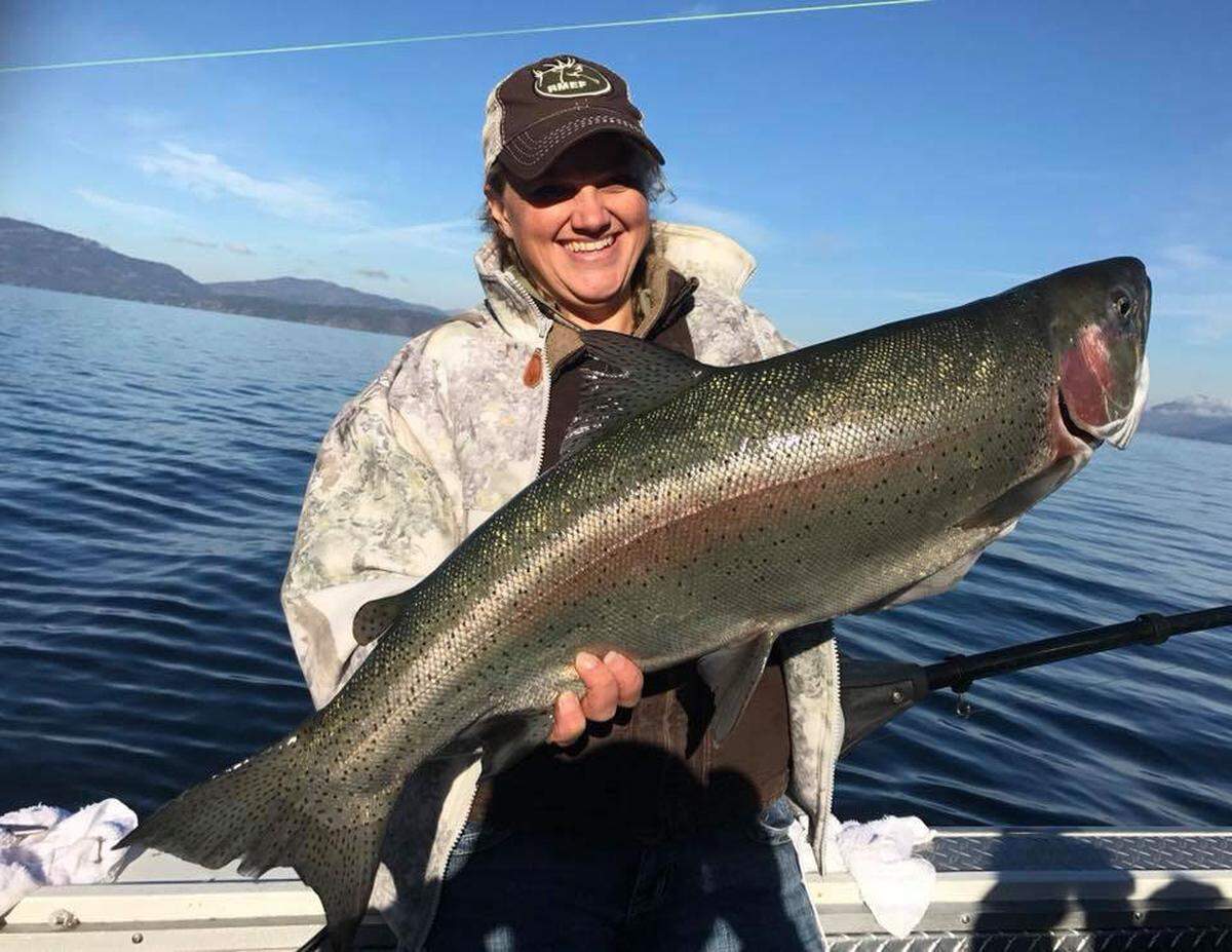 An angler poses with a massive Kamloops rainbow trout caught on Lake Pend Oreille.