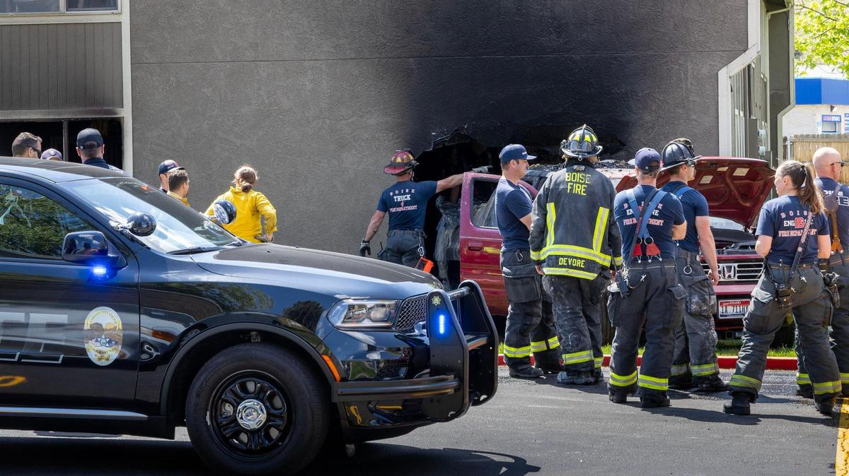Boise firefighters and other emergency responders arrived Monday at an apartment fire in Garden City. A pickup truck had backed up into the side wall of a ground-level apartment.