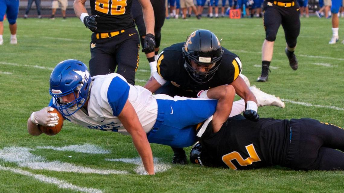 Emmett running back Westyn Smith dives for a touchdown Friday night during the Huskies’ 40-34 win at Bishop Kelly.