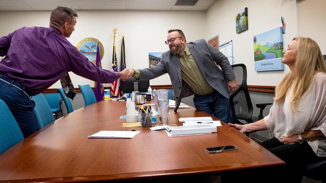 The Ada County Commissioner Ryan Davidson shakes the hand of Dr. Ryan Cole following an interview to fill a position on Central District Health board Monday, Aug. 9, 2021 at the Ada County Courthouse in Boise.