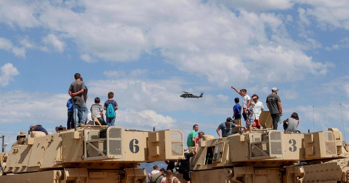 Spectators climb onto Idaho National Guard Abrams tanks to get a better view of the annual Gowen Thunder Airshow at Gowen Field Air National Guard Base at the Boise Airport, on Saturday, Aug. 26, 2023.