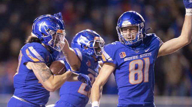 Boise State edge rusher Dylan Herberg (left) returns a blocked punt for a touchdown during the Broncos’ win over New Mexico last November. Herberg has been indefinitely suspended from the team after an arrest on suspicion of driving under the influence.