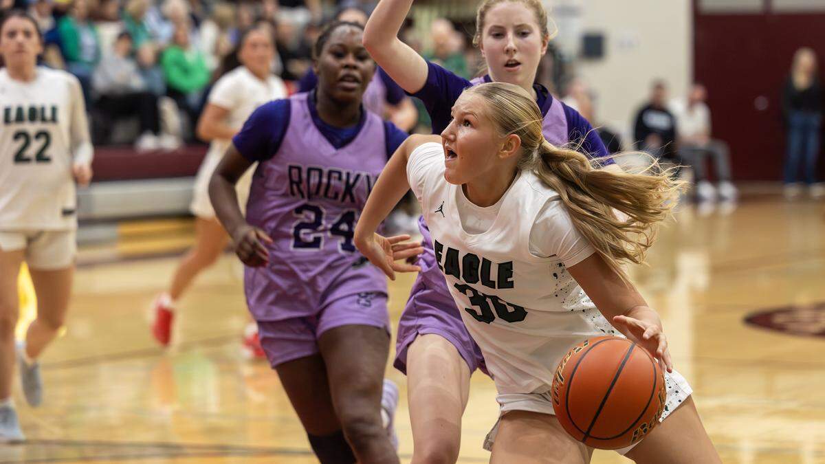 Eagle junior Berkley Jones moves past Rocky Mountain defenders as she attempts a shot during the semifinals of the 6A District Three girls basketball tournament held at Centennial High School, Saturday, Feb. 7, 2026.