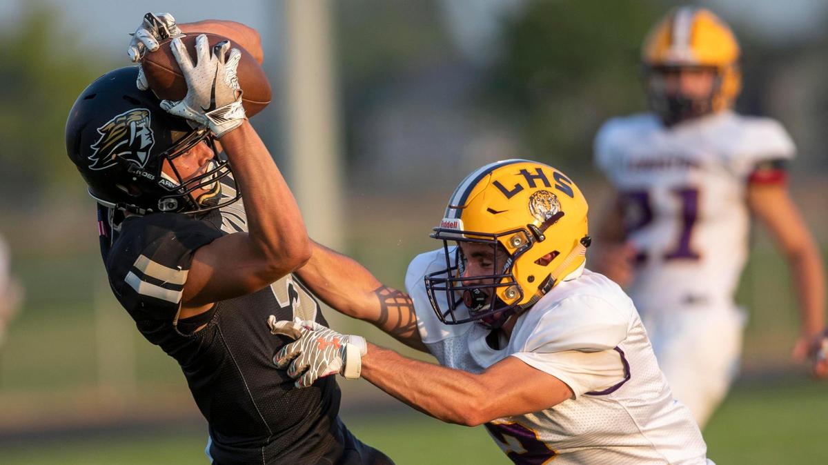 Kuna receiver Koltin Teater hauls in a long pass defended by Lewiston’s Kolby Hodges on Friday in Kuna.