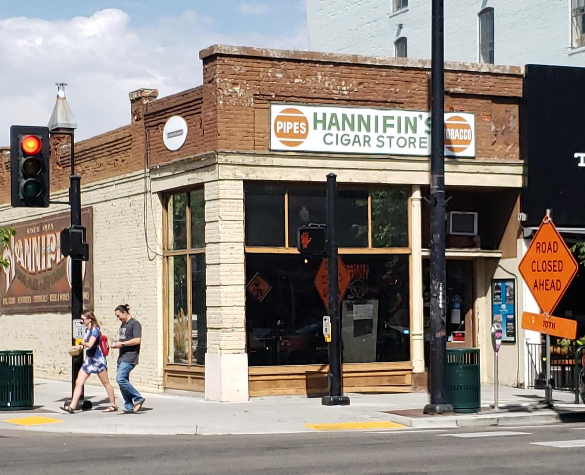 Haley Hill and Dan Cubero, who said they’re sad to see Hannifin’s Cigar Store close, walk across the street after leaving the shop. “It’s just a classic corner store,” Cubero said. “I enjoyed coming here.”