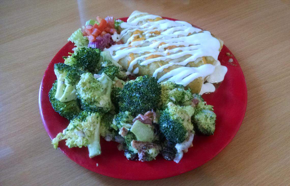 Chicken Enchiladas (corn tortillas, chicken, cheese, pico de gallo, green salsa and sour cream) and broccoli salad at Fiesta Chicken in Boise.