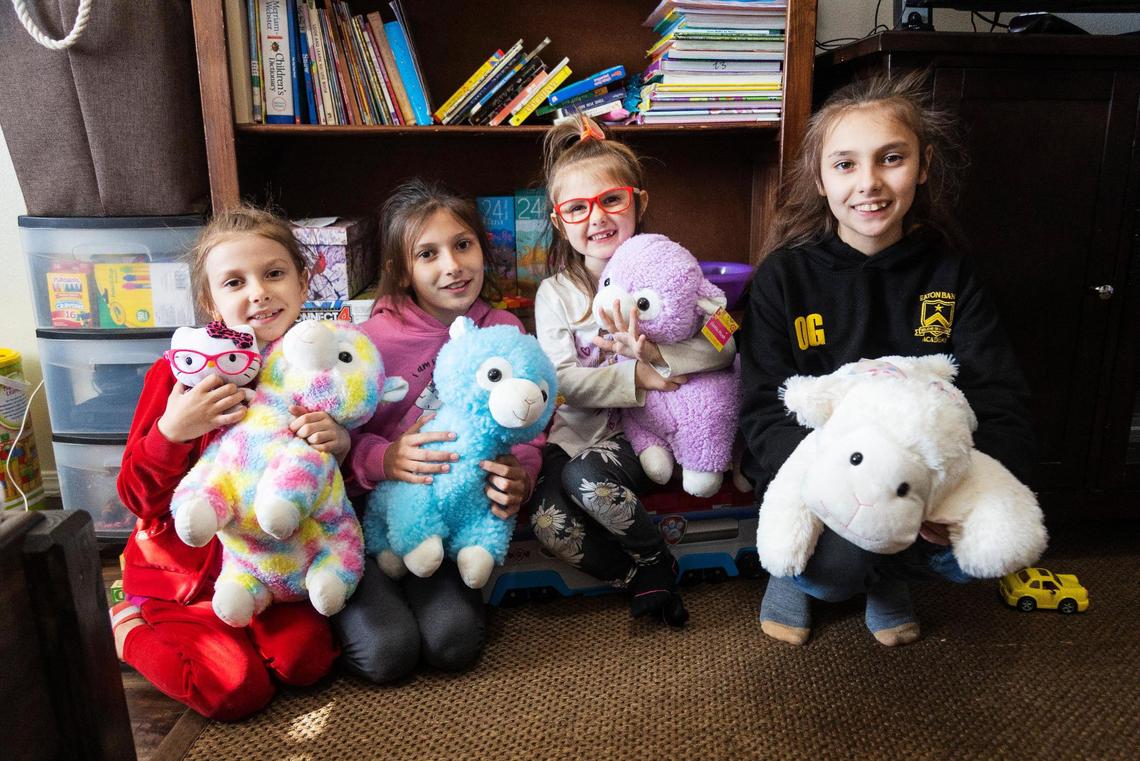 Ukrainian sisters Evelina, 6, Yelyzaveta, 10, Vanessa, 4, and Angelina, 11, hold the stuffed animals they received once they arrived at their host family’s house in Idaho.