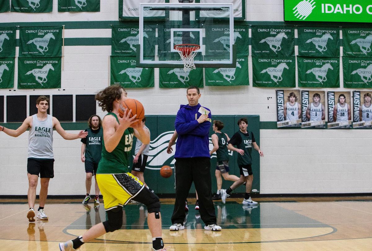 Eagle boys basketball coach Cody Pickett keeps a watchful eye over his team at Friday’s practice. Pickett stepped away from the team after doctors recommended open-heart surgery to clear a blockage in an artery known as “the widowmaker.” But a second opinion led him to the University of Washington, where a leading surgeon placed a stent in his heart, allowing Pickett to return to coaching.