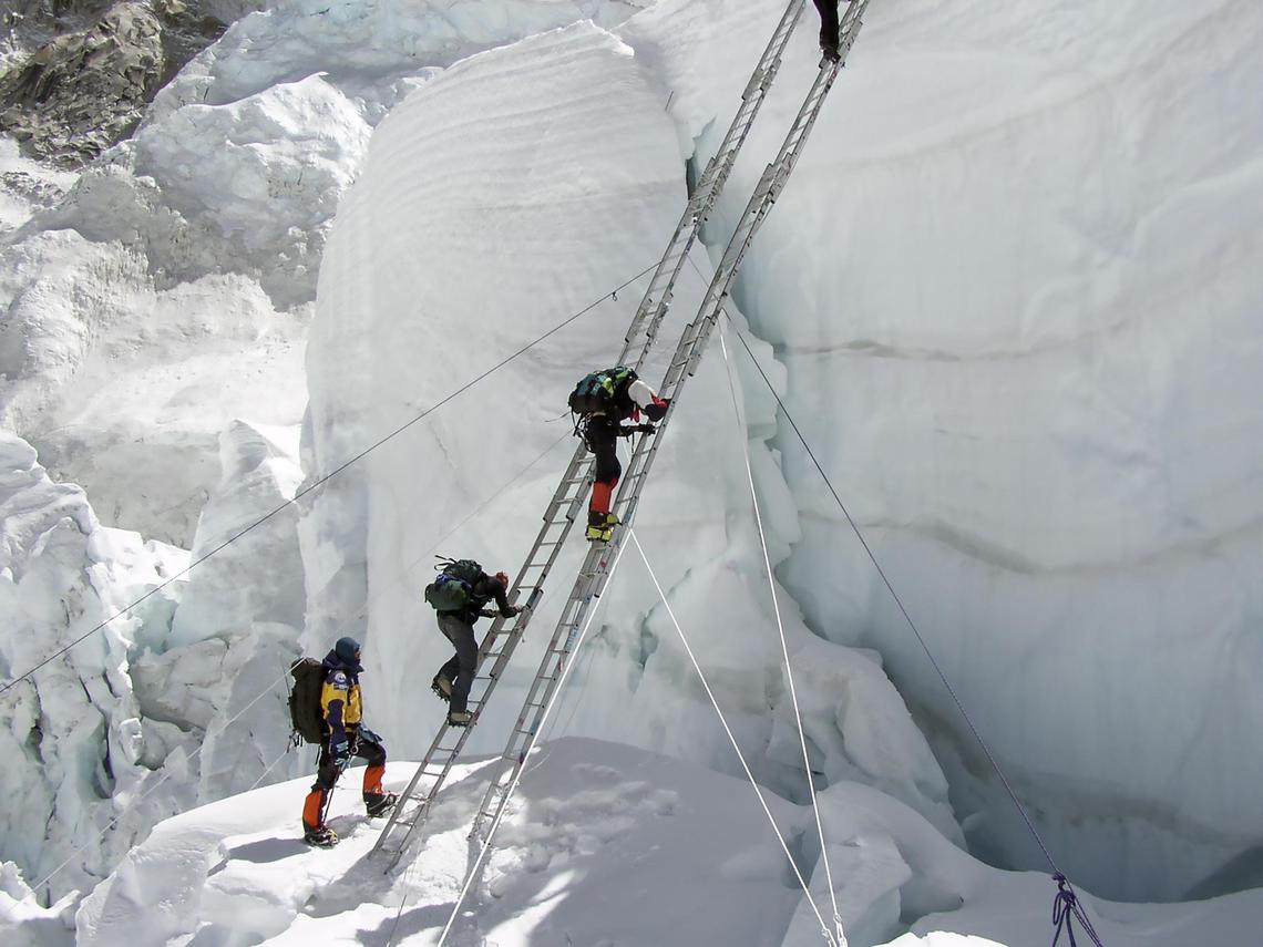 Ang Dorjee Sherpa, bottom left, helps climbers safely traverse the Khumbu icefall on one of his many Everest expeditions as a guide.