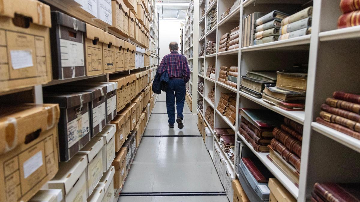 David Matte, State Archives administrator, walks past shelves of documents housed at the Idaho State Archives in Boise.