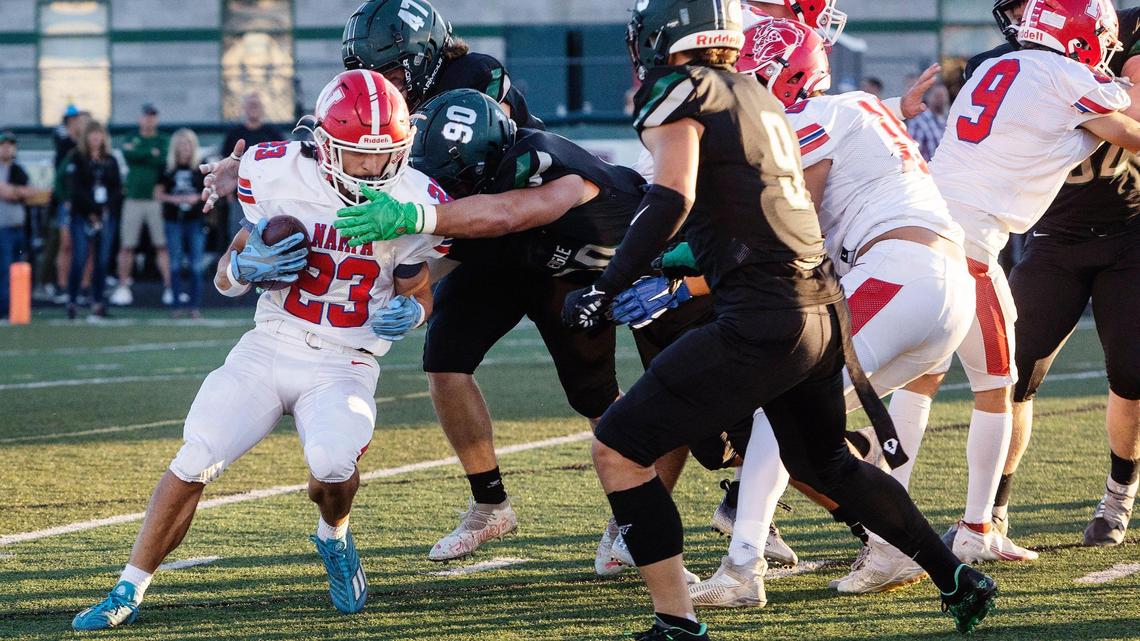 Eagle edge Seth Brock (90) reaches out to stop Nampa’s Dante Avjian on Friday at Eagle.