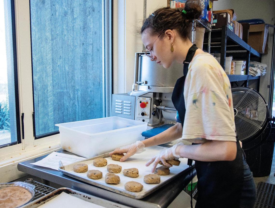 Holly Johnson places dough for oatmeal raisin cookies on an oven pan at Wildflour Bakery on June 29, 2021. Bigwood Bread in Ketchum has bought Wildflour Bakery.