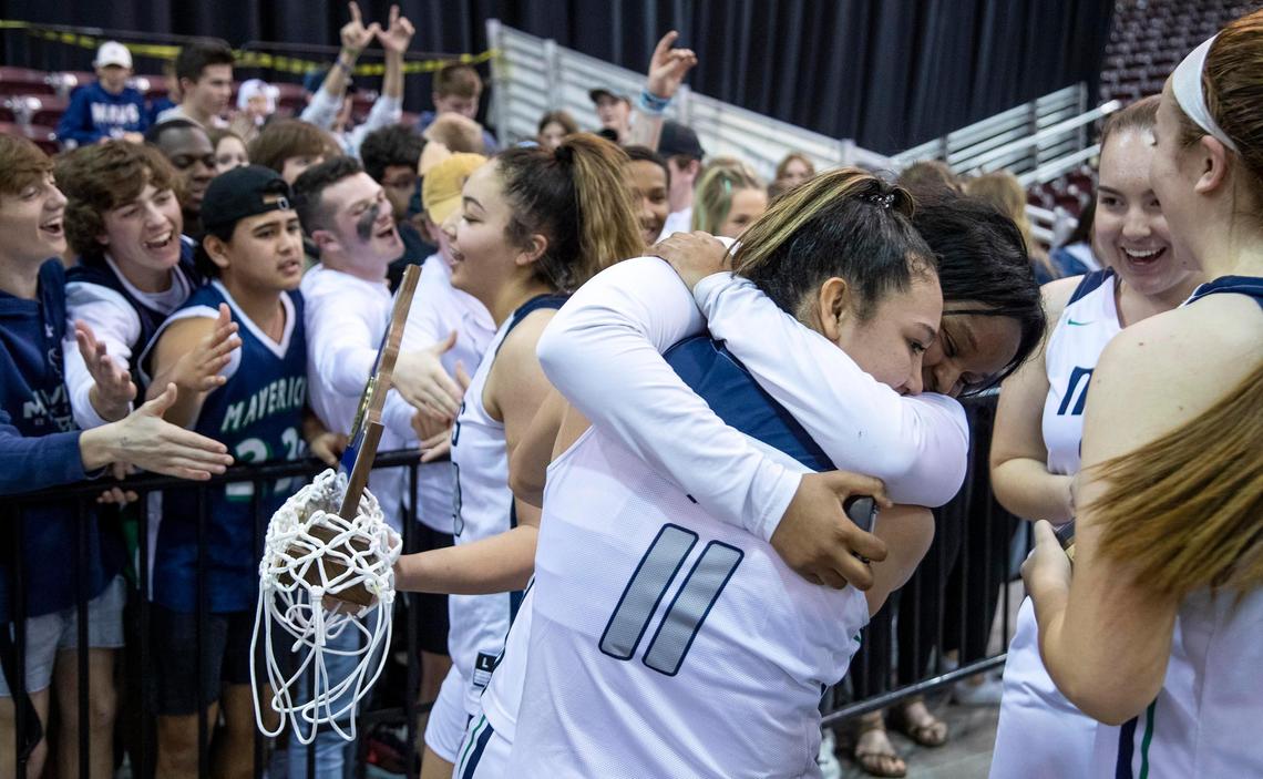 Mountain View’s Laila Saenz and D’Nia Williams embrace as the team shares the 5A girls state basketball championship trophy with the student section Saturday, Feb. 22, 2020 at Ford Idaho Center in Nampa.