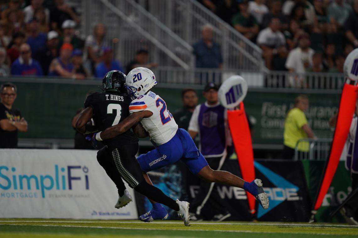 Boise State defensive back Davon Banks tackles Hawaii’s Tylan Haines during a 2024 win.