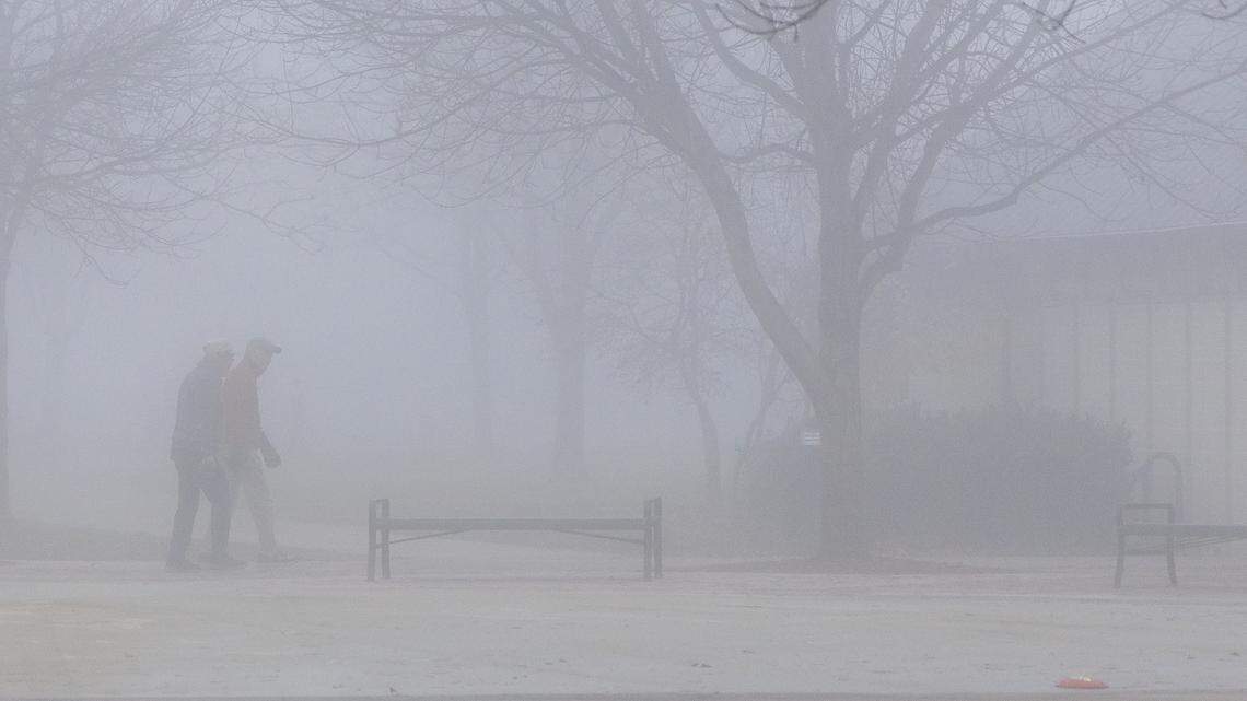People walk in the fog at Julius M. Kleiner Memorial Park.