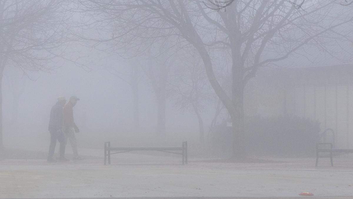 People walk in the fog at Julius M. Kleiner Memorial Park in Meridian, Tuesday, Nov. 18, 2025.