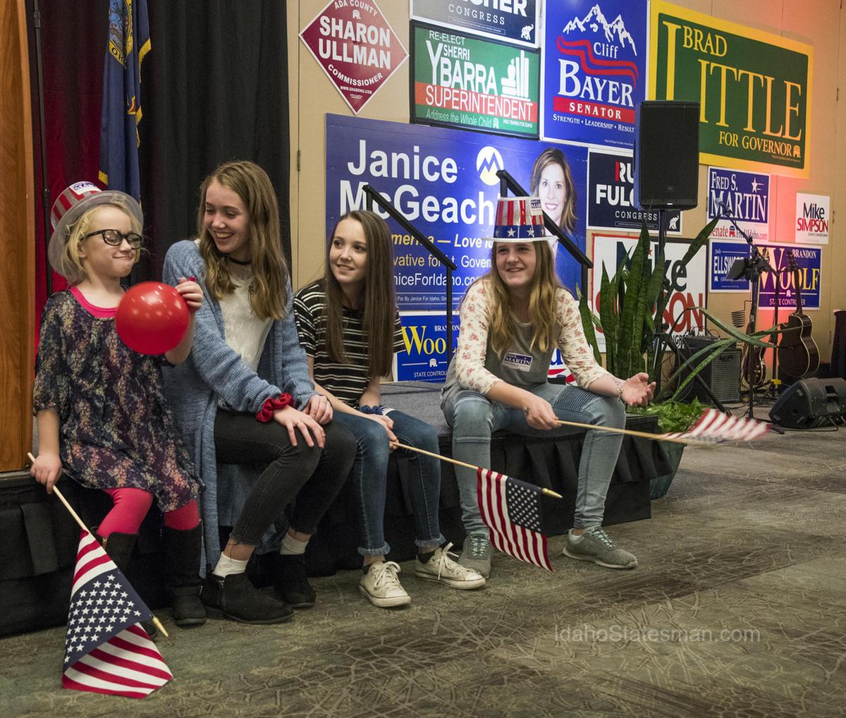 Oaklee Swenson, 5, left, of Mountain Home, Suzanna Farris, 15, Makenna Farris, 13, both of Boise, and Lainee Martin, 11, of Rupert, get into a festive mood with balloons, hats and flags at the Republican election night party Tuesday, Nov. 6, 2018 at the Riverside in Garden City.