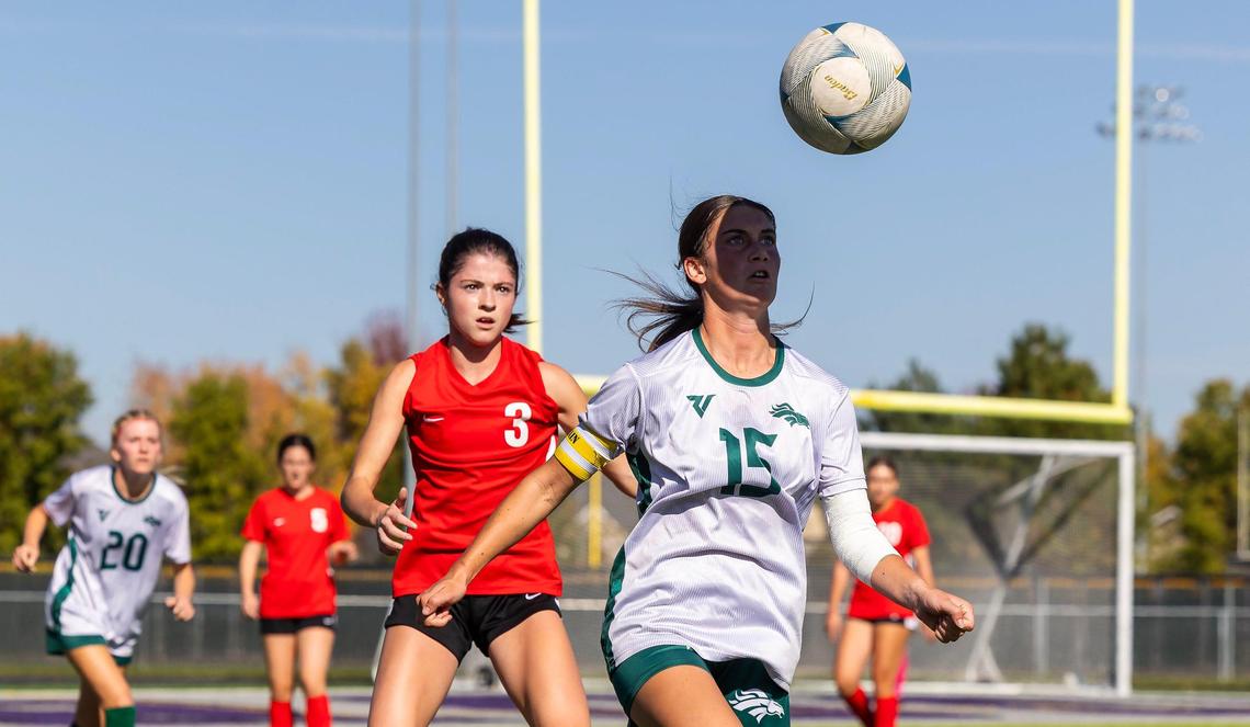 Eagle junior Naomi Hilbig, right, receives a throw-in during the 5A state semifinals last fall.