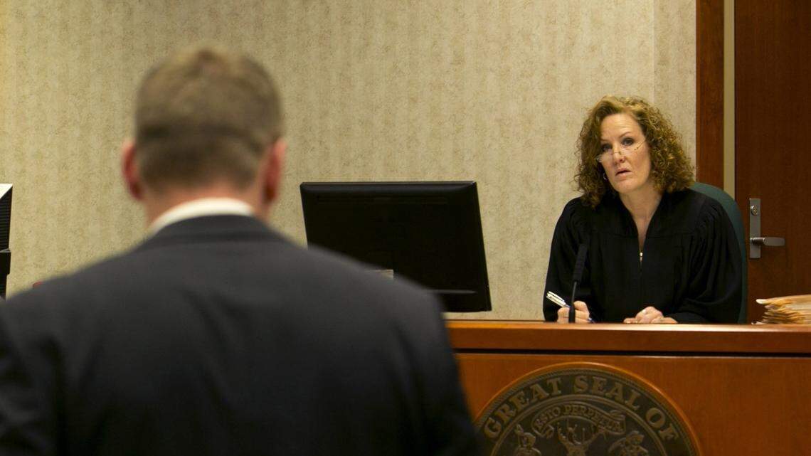 Twenty-two magistrate judges are based in Ada County, and part of their funding comes from cities. Ada County Magistrate Judge Theresa Gardunia talks with a lawyer during a 2015 arraignment at the county courthouse in Boise.
