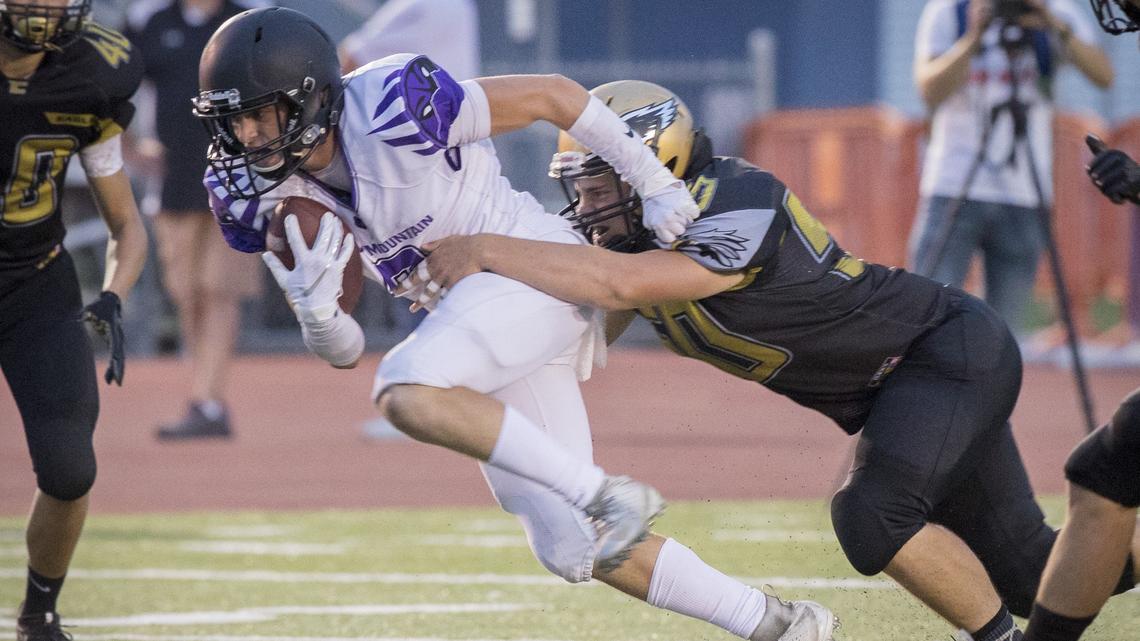 Rocky Mountain’s Kaden Birch tries to slip free from a tackle during the Grizzlies’ 50-17 win over Capital at Dona Larsen Park on Friday, Sept. 7, 2018.