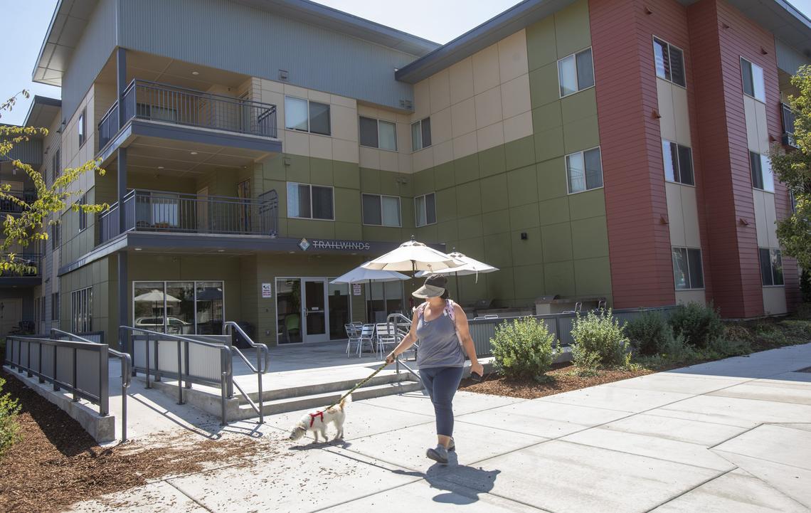 Denise Miramontes and Lucky walk to the Greenbelt on East 42nd Street in Garden City. The Trailwinds apartments were already in the neighborhood when developer Bill Truax added apartments, townhouses and a public charter school.