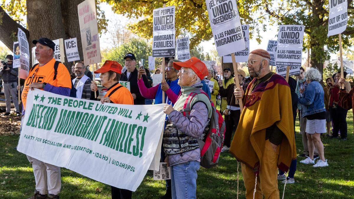 A large group of protesters gather in Caldwell Monday to protest a FBI and ICE raid in Wilder on Sunday, Oct. 19, 2025. Over a hundred people carrying posters decrying ICE and President Trump's immigration policies gathered in Justice Park across the the Canyon County Administration Building, where FBI and Idaho law enforcement agencies had planned a news conference-but it was cancelled.