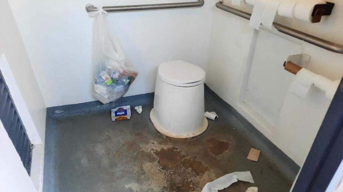 Trash litters the ground of a vault toilet at the Kirkham Hot Springs day-use recreation site near Lowman in this 2021 file photo. With dozens of positions cut from national forests in Idaho, one forest worker warned that vault toilets likely won’t be cleaned during the busy summer season.