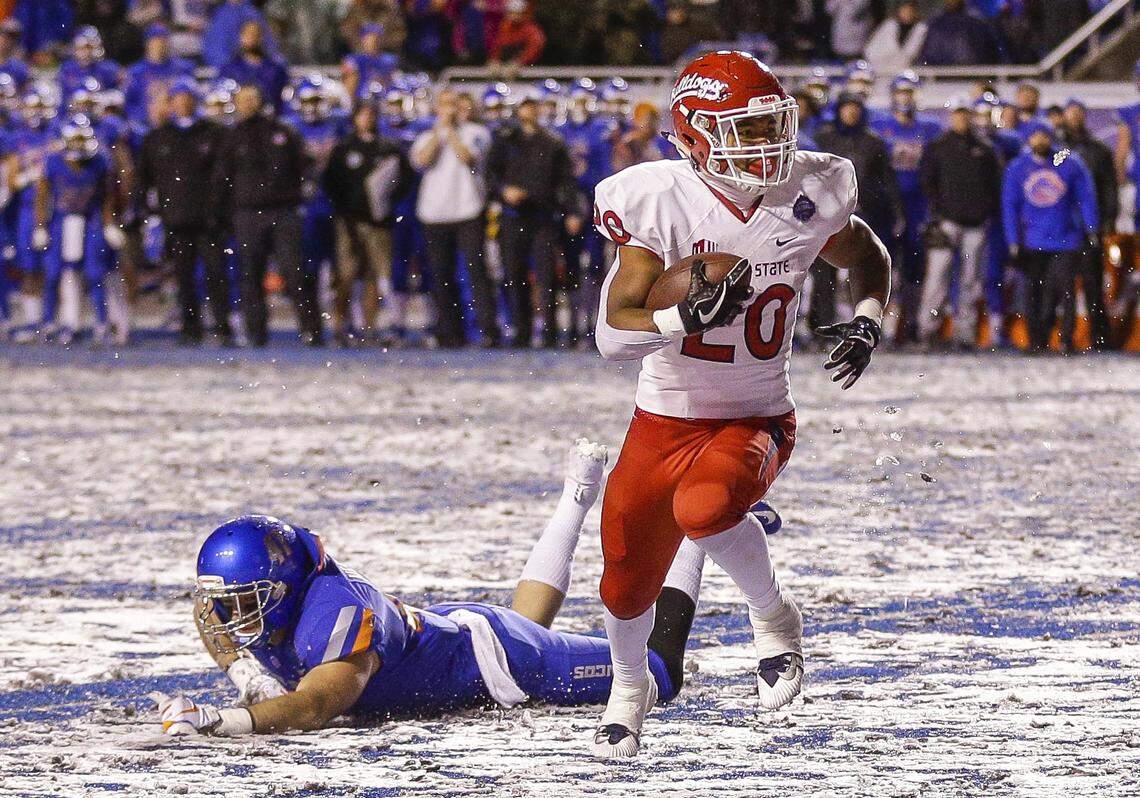 Fresno State running back Ronnie Rivers (20) runs past the diving tackle attempt by Boise State linebacker Will Heffner (41) for the game winning touchdown in overtime against in an NCAA college football game for the Mountain West championship, Saturday, Dec. 1, 2018, in Boise, Idaho. Fresno State won 19-16. (AP Photo/Steve Conner)