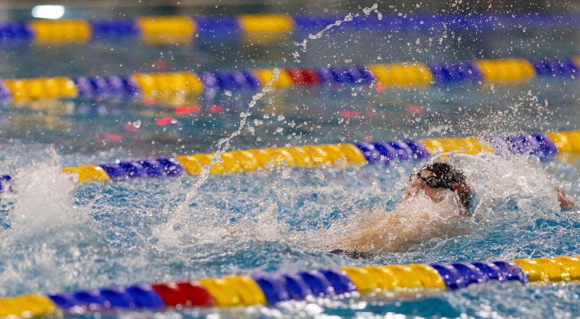 Boise’s Tyler Young competes in the 100-yard backstroke at the 5A state meet held at the West Family YMCA and Boise City Aquatic Center last season.