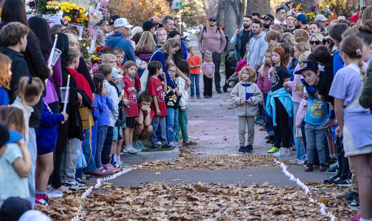 People gather at the intersection of Harrison Blvd. and Ada St. in Boise on Saturday, Nov. 15, 2025 for a memorial to Mora Gerety, a child who was killed by a vehicle while crossing the street.