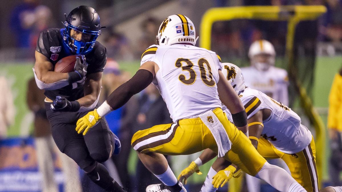 Boise State running back George Holani finds some running room in the second half before Wyoming linebacker Logan Wilson brings him down during the Broncos’ 20-17 overtime win in Albertsons Stadium.