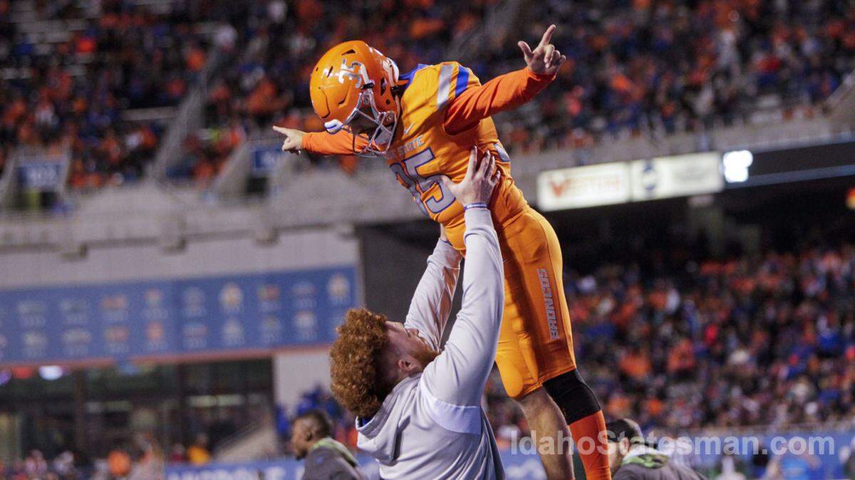 Boise State kicker Jonah Dalmas is lifted in the air by defensive tackle Scott Matlock after a successful extra point against Colorado State on Oct. 29. Dalmas is 16-of-19 on field goals this season.